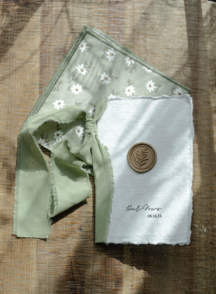 wedding vow book with green ribbon