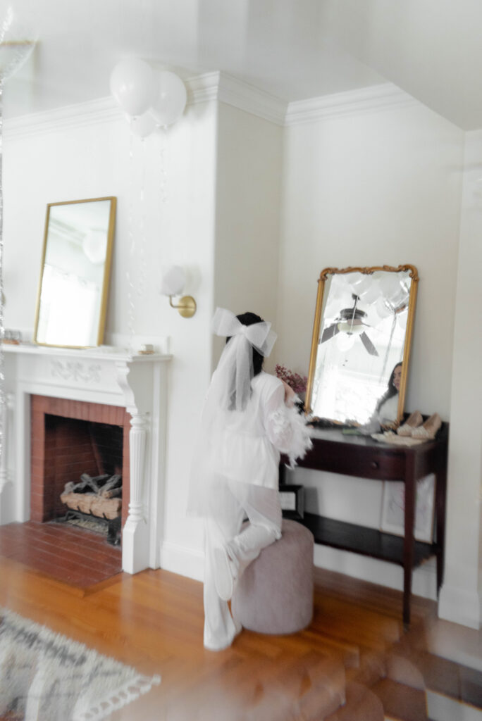 bride getting ready in mirror 