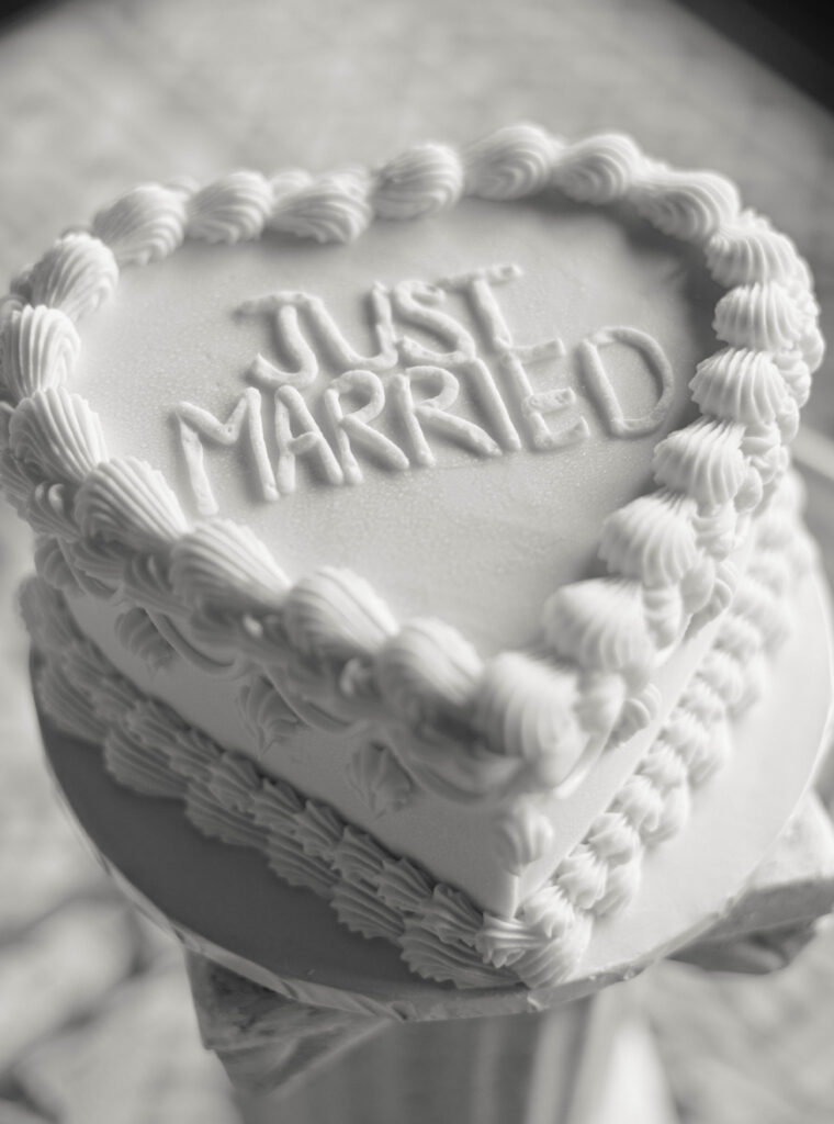 black and white wedding cake that says "Just Married" 