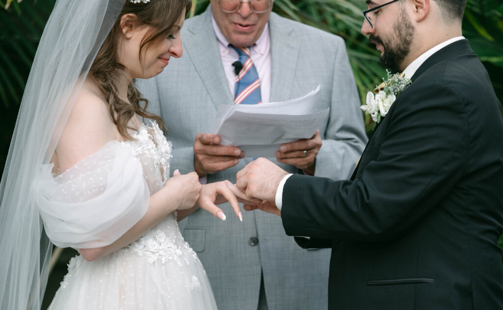 Couple exchanging rings at wedding alter