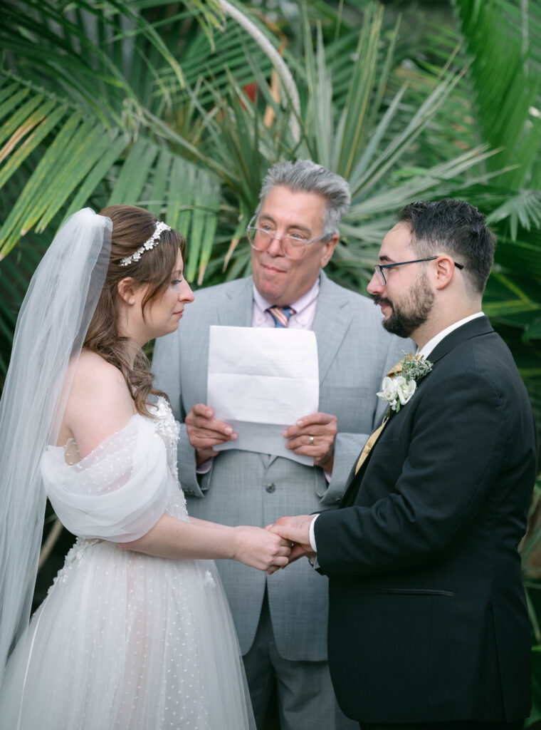 Couple reading vows at wedding alter