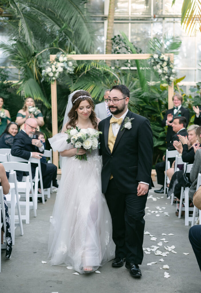 Couple walking down the aisle at Roger Williams Botanical Garden