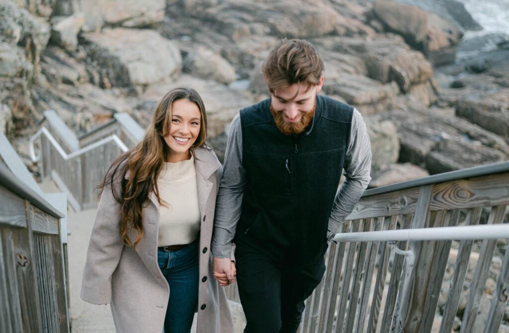 Couple walking us the oceanfront stairs at Cliff House Maine