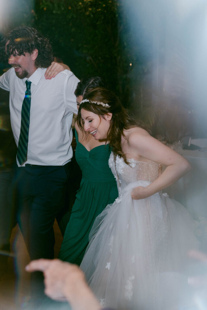 Bride and guests dancing at wedding reception